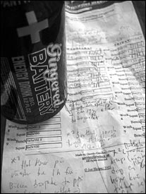 Energy drink sitting on top of printed out program